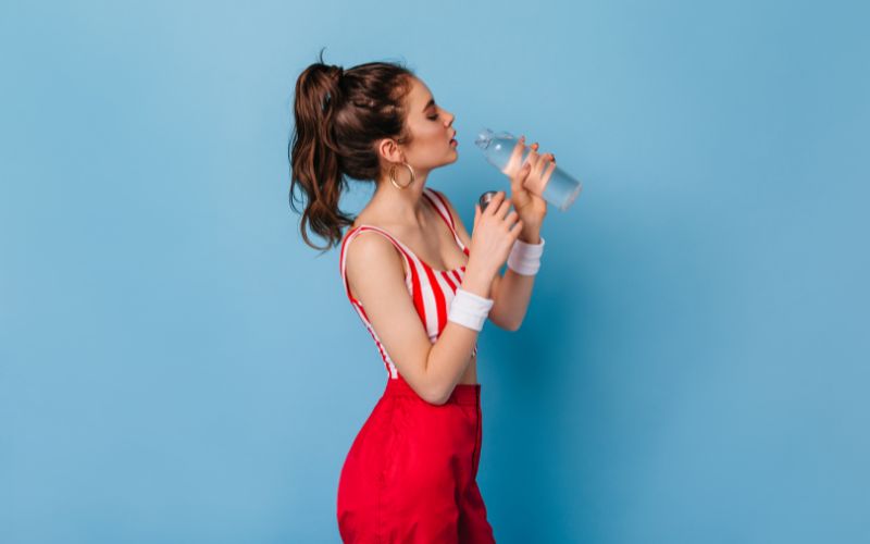 Women in colorful clothes drinking water-Body Water Percentage