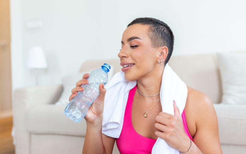 Women drinking water after doing exercise-Body Water Percentage